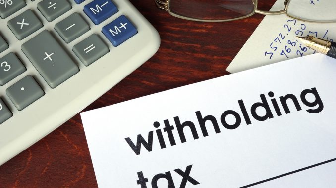 Withholding tax written on a paper. Financial concept. Understand What to Do About Withholding Tax in Accounting
